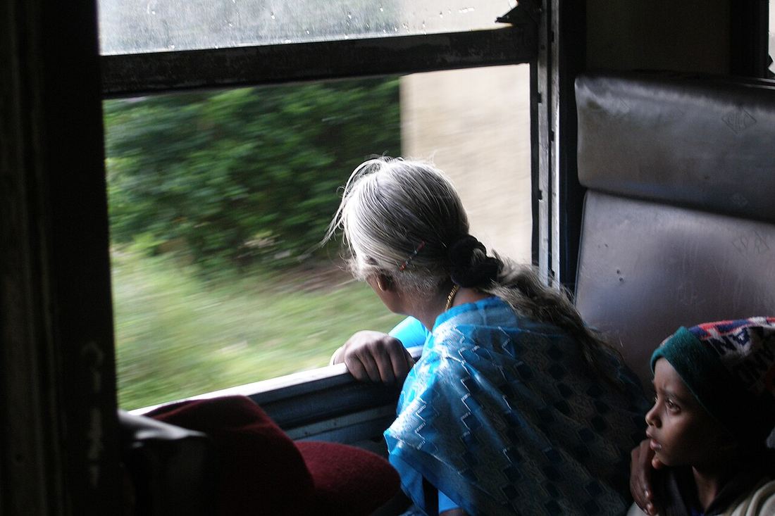 Passengers looking through an open train window in Sri Lanka